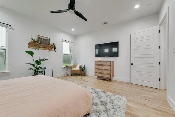 a bedroom with a bed and a flat screen tv
