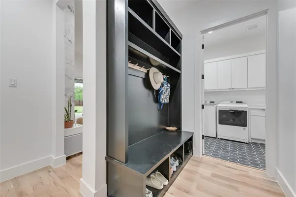 a kitchen with white cabinets and refrigerator