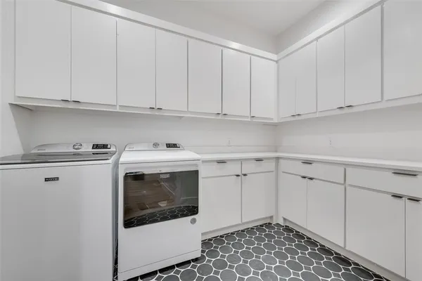 a utility room with sink dryer and washer