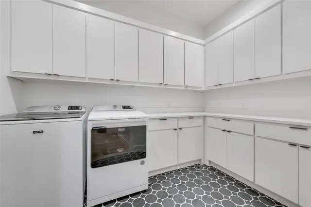 a utility room with sink dryer and washer