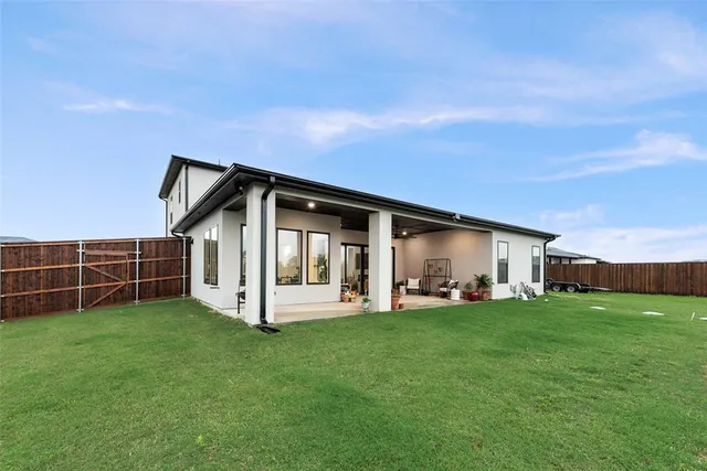 a view of a house with a yard and garden
