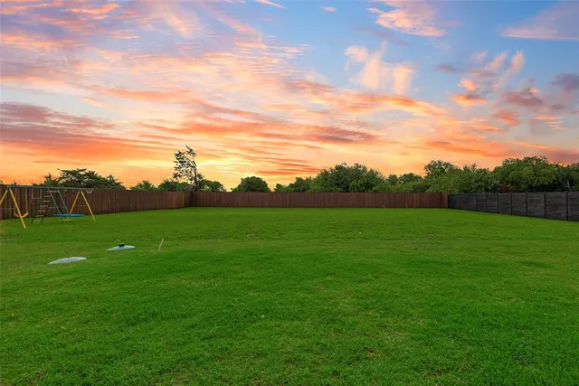 a view of a grassy field with mountain