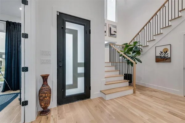 a view of entryway and hall with wooden floor