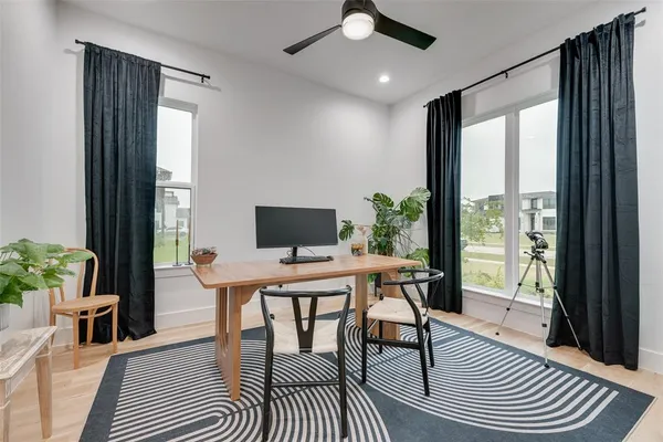 a view of a workspace with furniture window and wooden floor
