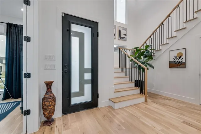 a view of entryway and hall with wooden floor