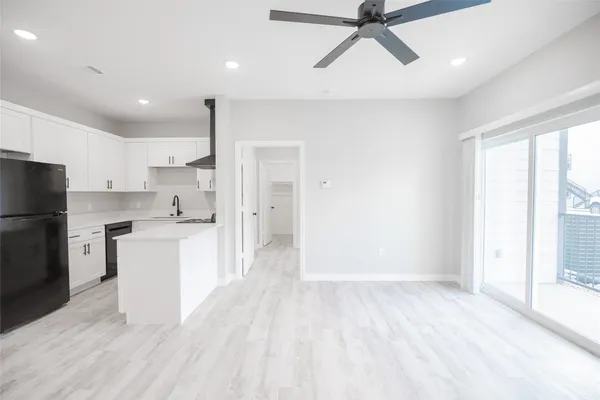 a view of a kitchen with a sink and stainless steel appliances