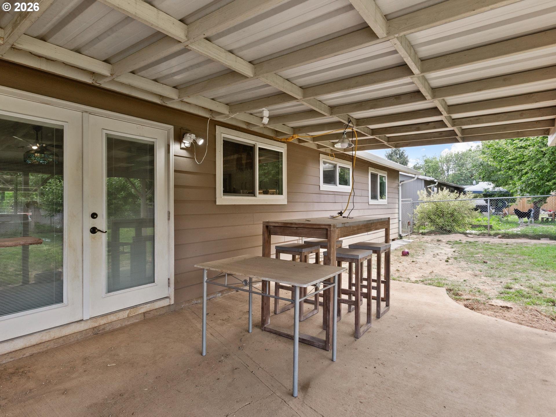 1719 Southwest 1st Street Battle Ground, WA 98604 - Photo 28 of 37 a patio with a table and chairs and potted plants