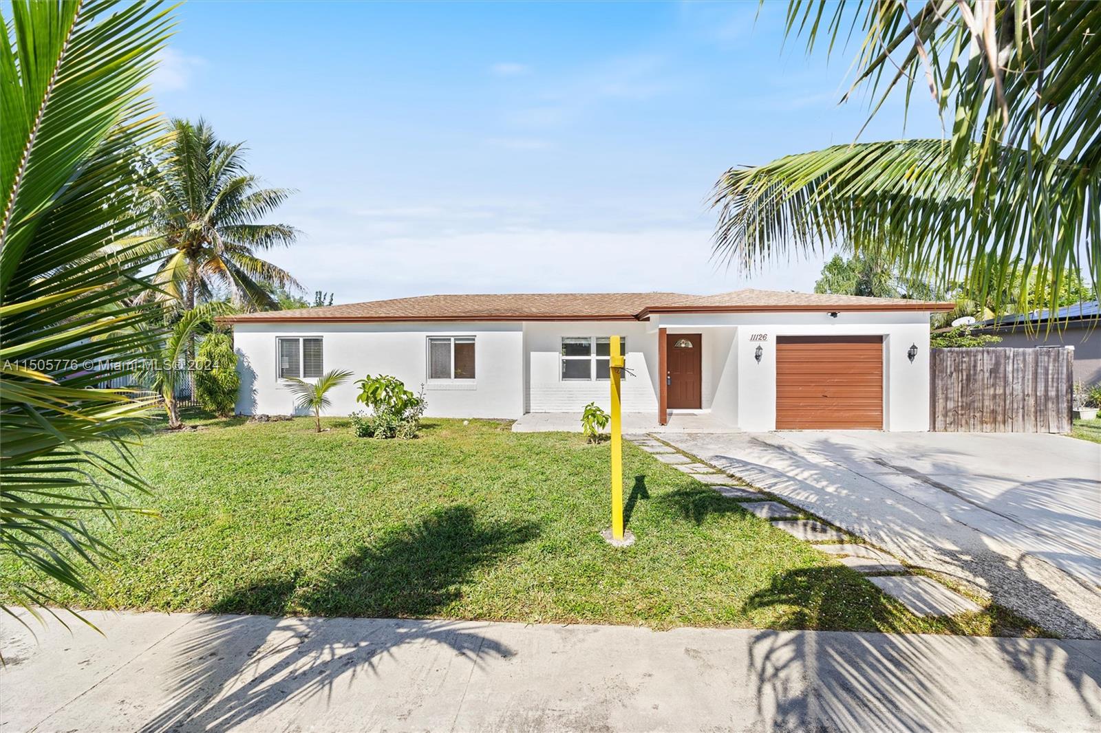 11126 Delta Circle Boca Raton, FL 33428 - Photo 1 of 22 a front view of house with yard and porch