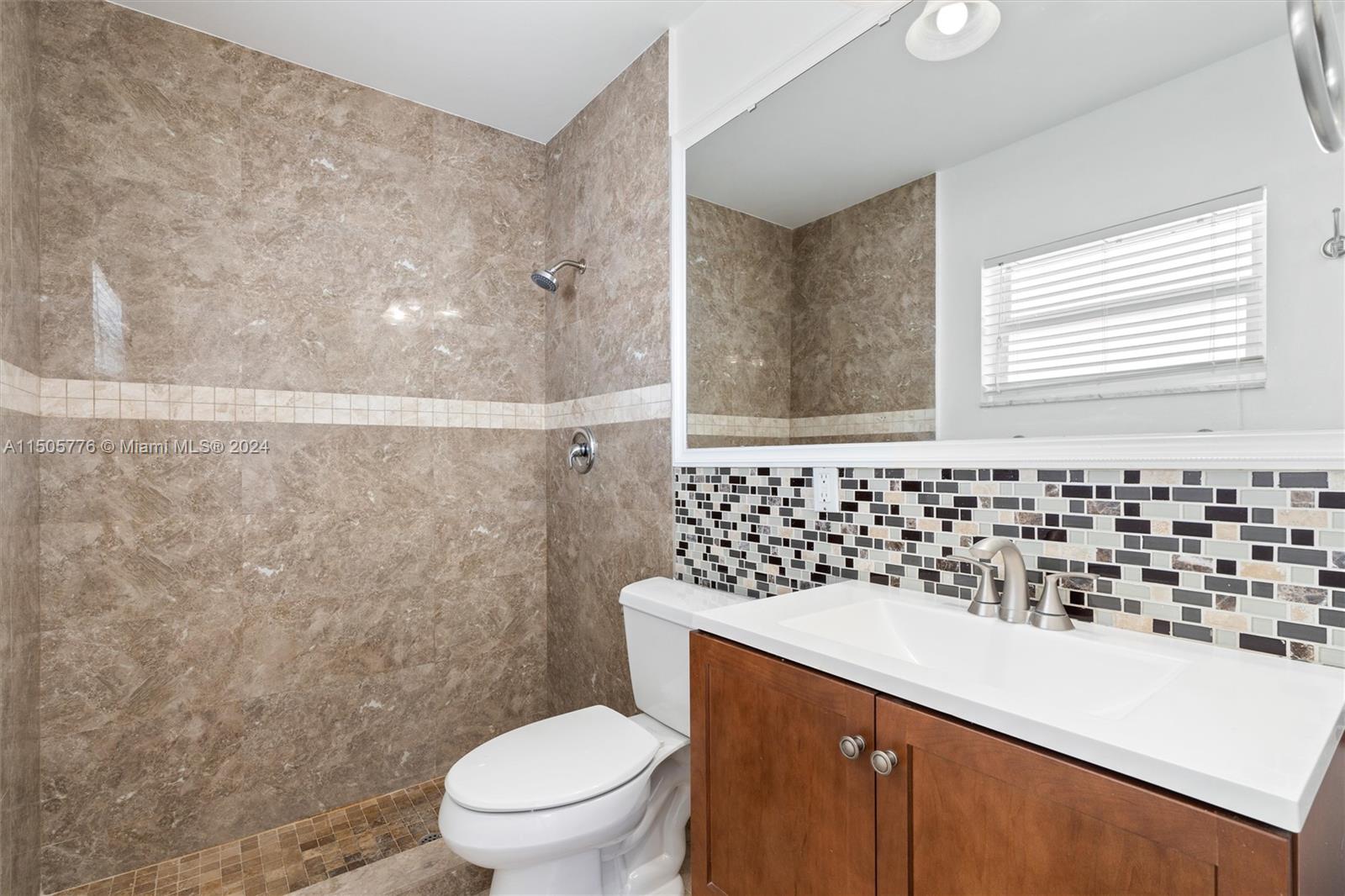 11126 Delta Circle Boca Raton, FL 33428 - Photo 13 of 22 a bathroom with a sink toilet vanity and shower