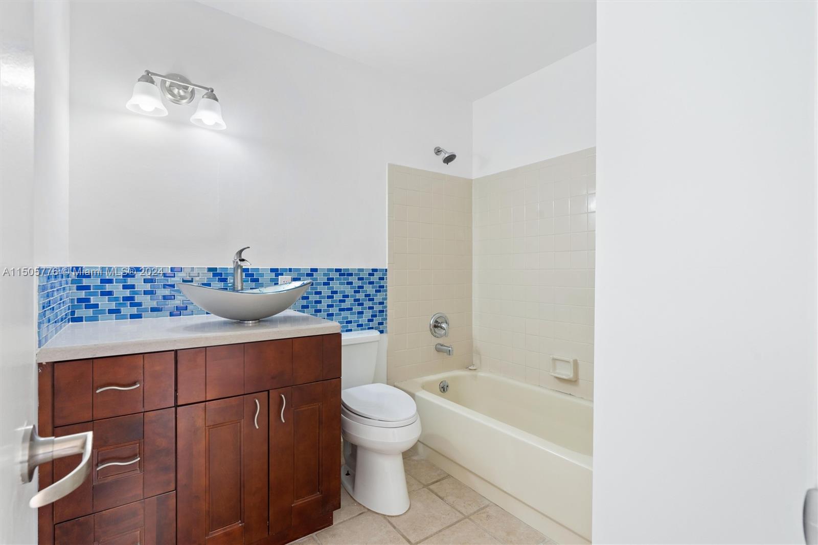 11126 Delta Circle Boca Raton, FL 33428 - Photo 16 of 22 a bathroom with a granite countertop sink a toilet and bathtub