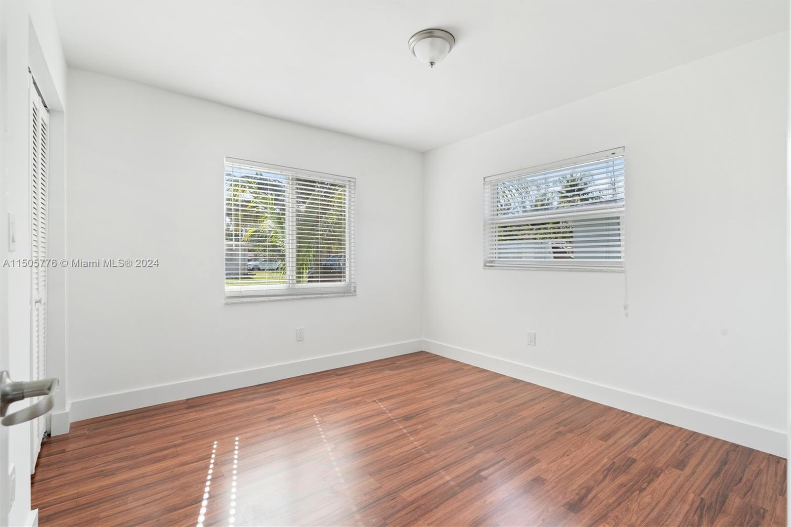 11126 Delta Circle Boca Raton, FL 33428 - Photo 17 of 22 a view of a room with wooden floor and windows