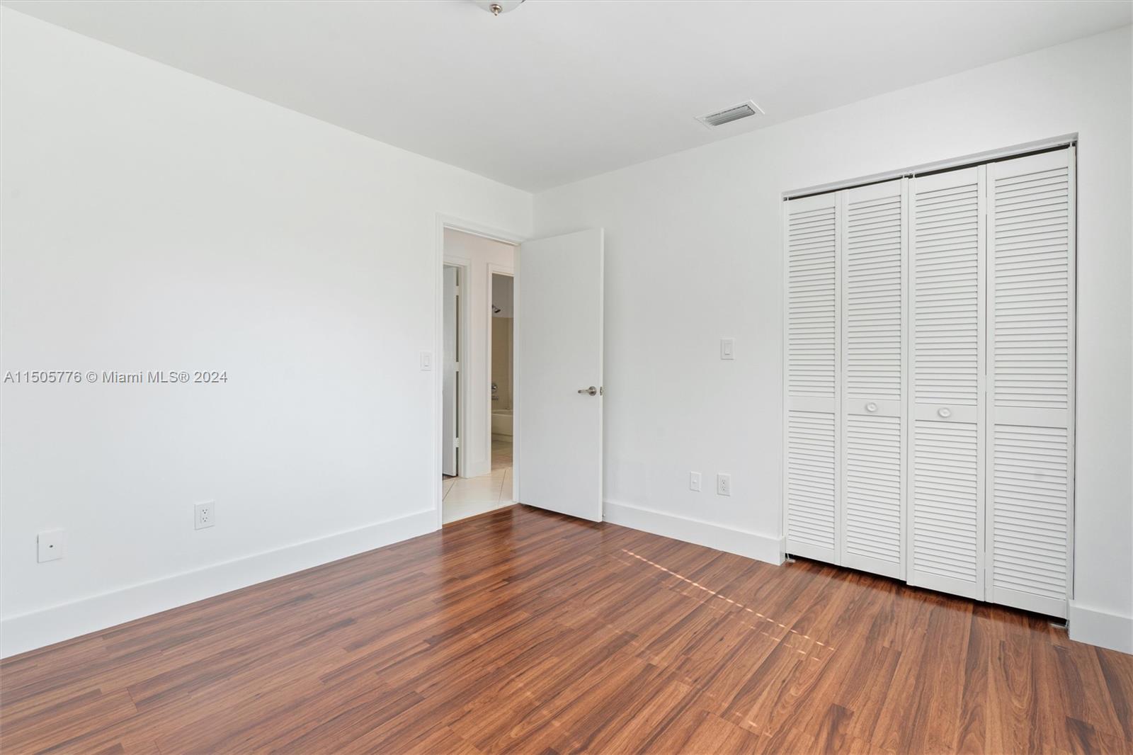 11126 Delta Circle Boca Raton, FL 33428 - Photo 18 of 22 a view of an empty room with wooden floor