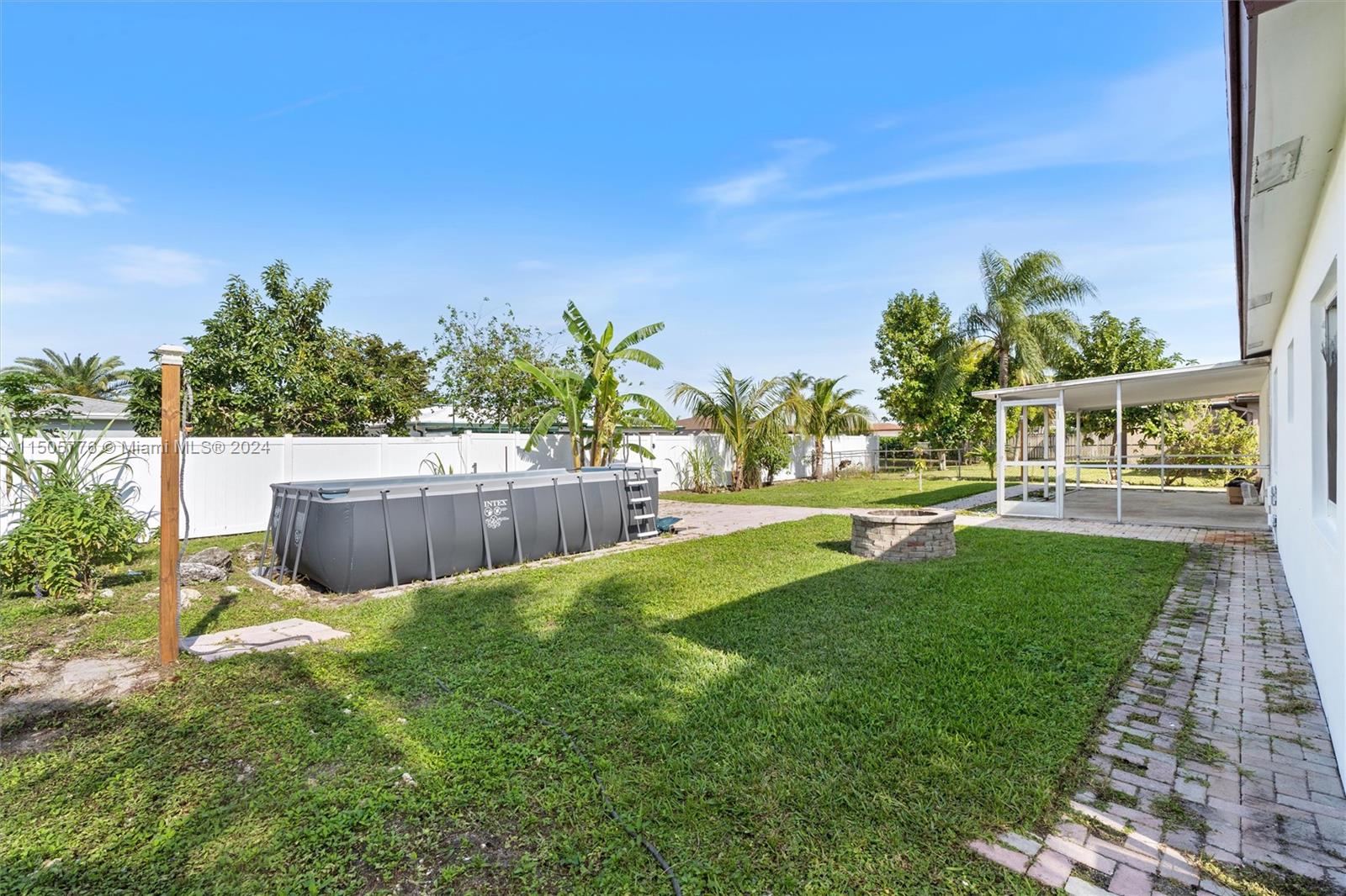 11126 Delta Circle Boca Raton, FL 33428 - Photo 20 of 22 a view of a swimming pool with an outdoor seating and a garden
