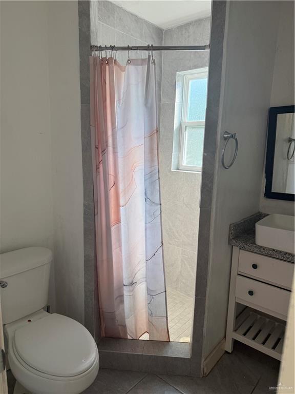 708 North 6th Street McAllen, TX 78501 - Photo 11 of 27 Bathroom featuring vanity, a stall shower, and tile patterned flooring