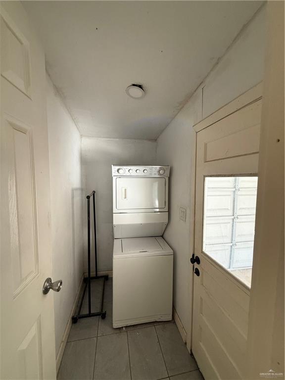708 North 6th Street McAllen, TX 78501 - Photo 6 of 27 Laundry area featuring stacked washing machine and dryer and light tile patterned floors
