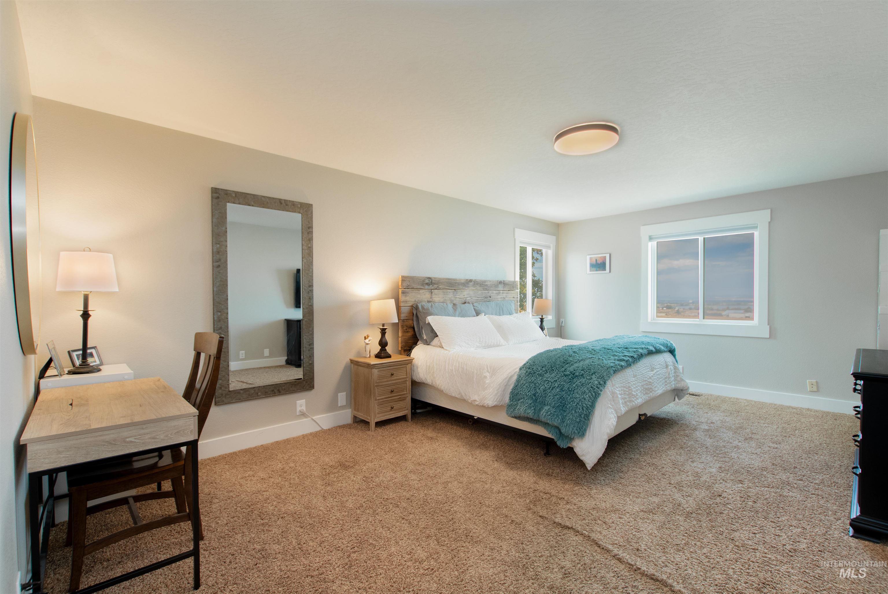 12369 Deer Flat Road Nampa, ID 83686 - Photo 32 of 50 Carpeted room featuring a single window with wood-finish trim, neutral wall paint, and a ceiling-mounted light fixture