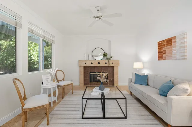 a living room with furniture a rug and a table