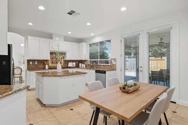a kitchen with sink cabinets and dining table