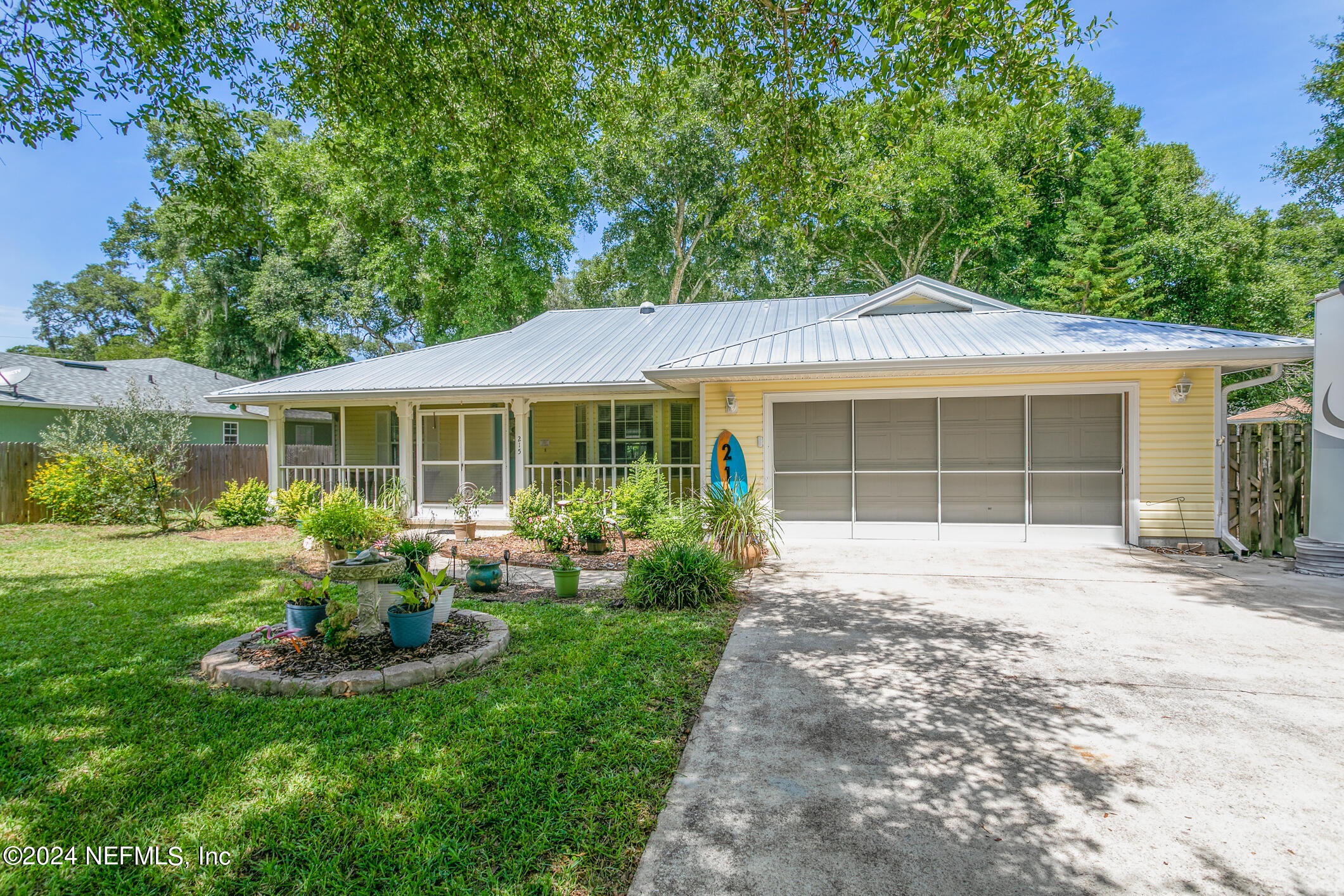 215 Hawthorne Road St. Augustine, FL 32086 - Photo 4 of 52 a front view of a house with a garden and porch