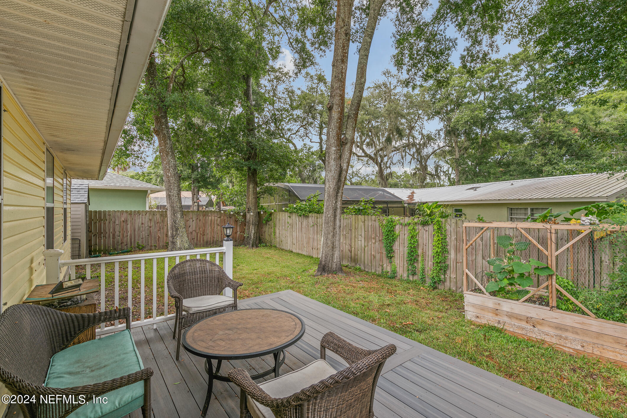215 Hawthorne Road St. Augustine, FL 32086 - Photo 42 of 52 a view of a chair and table in backyard of the house