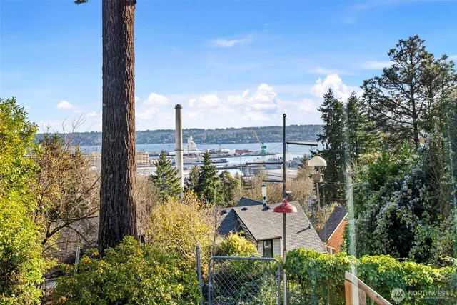 an aerial view of residential house with outdoor space and trees all around