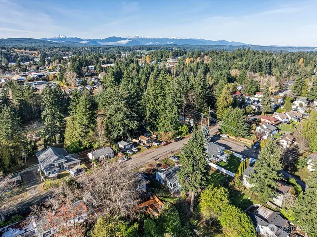 an aerial view of a building and mountain view in back