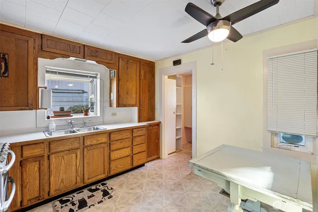 a spacious bathroom with a sink a mirror and shower