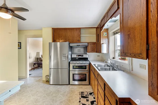 a kitchen with a stove a sink and a refrigerator