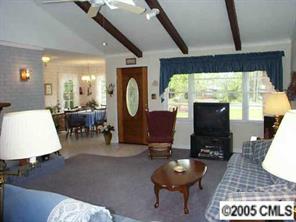 3079 Lake Shore Road South Denver, NC 28037 - Photo 2 of 8 a living room with furniture a rug and a large window