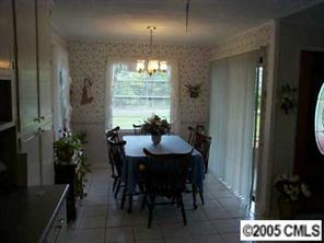 3079 Lake Shore Road South Denver, NC 28037 - Photo 5 of 8 a view of a dining room with furniture and chandelier