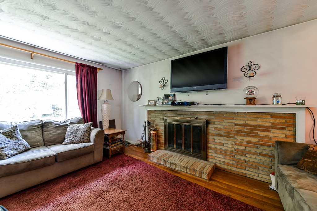 259 Potter Road Framingham, MA 01701 - Photo 3 of 23 a living room with furniture and a flat screen tv