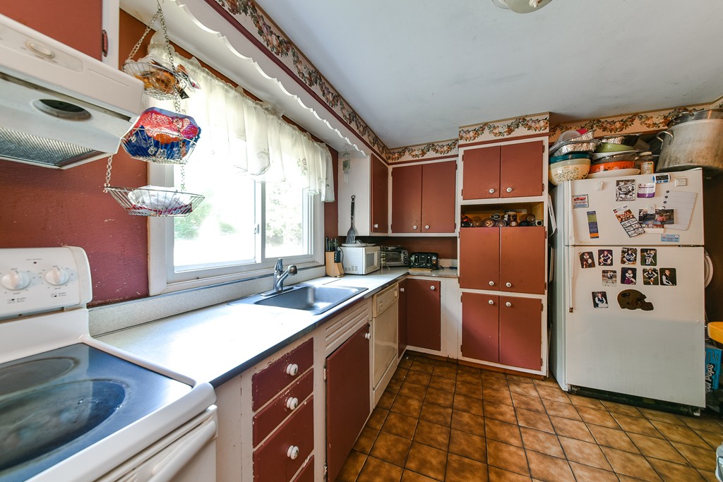 259 Potter Road Framingham, MA 01701 - Photo 5 of 23 a kitchen with a refrigerator and a sink