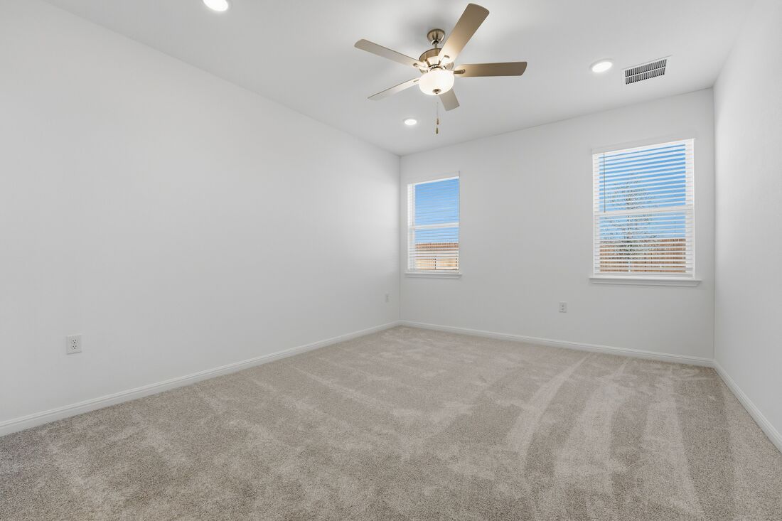 1712 Lorant Lane Pflugerville, TX 78660 - Photo 12 of 36 an empty room with windows and ceiling fan