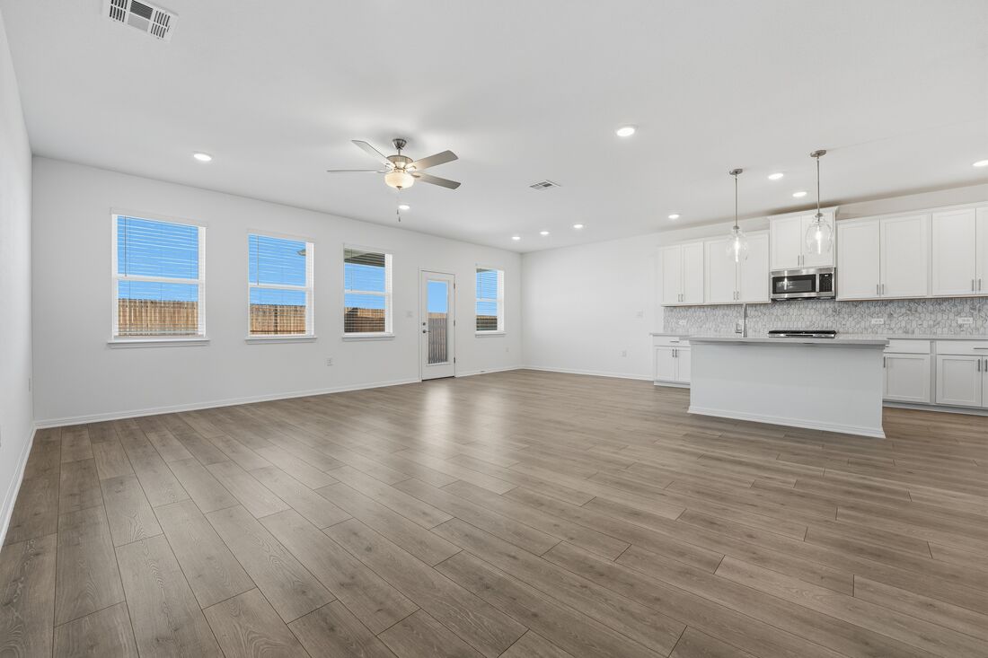 1712 Lorant Lane Pflugerville, TX 78660 - Photo 7 of 36 a view of a kitchen with a sink wooden cabinets and a window