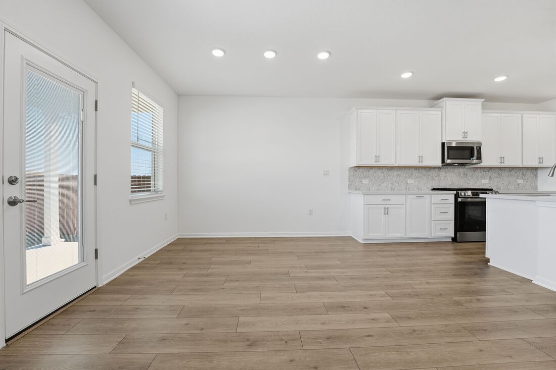 1712 Lorant Lane Pflugerville, TX 78660 - Photo 9 of 36 a view of kitchen with wooden floor and electronic appliances