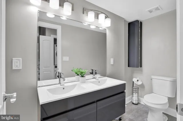 a bathroom with a toilet a sink and mirror