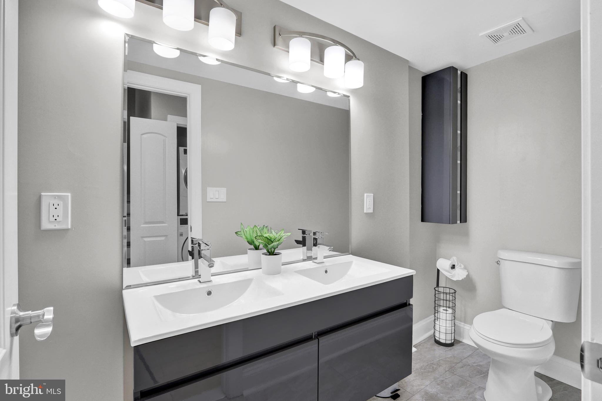 1167 Morse Street Northeast, Unit B1 Washington, DC 20002 - Photo 12 of 18 a bathroom with a toilet a sink and mirror