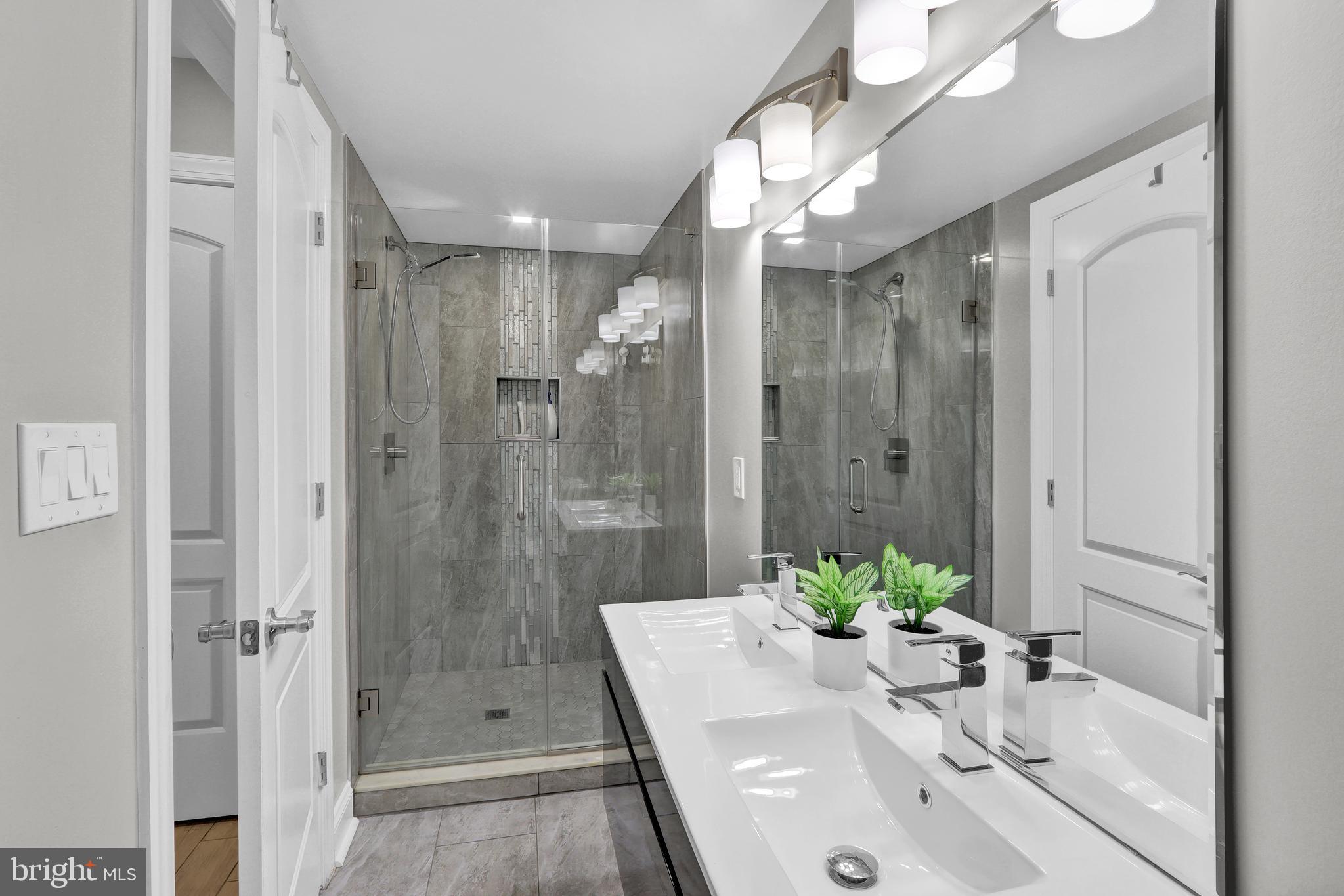 1167 Morse Street Northeast, Unit B1 Washington, DC 20002 - Photo 13 of 18 a bathroom with a sink a shower and a mirror