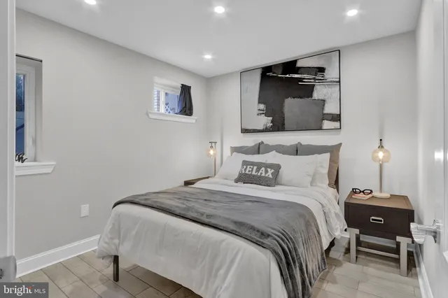 a bedroom with a bed and a lamp