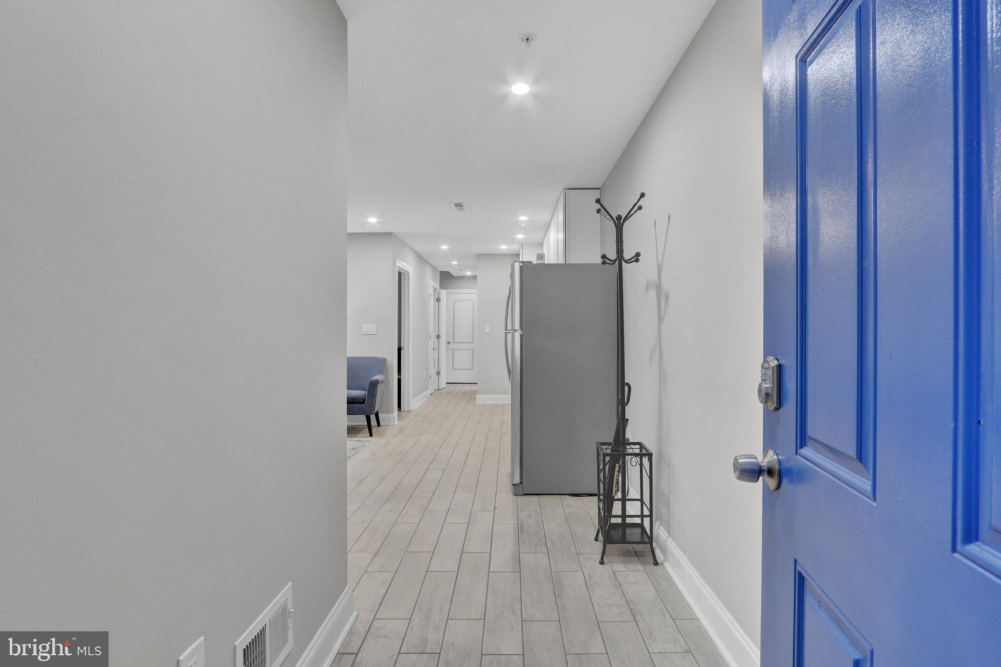 1167 Morse Street Northeast, Unit B1 Washington, DC 20002 - Photo 3 of 18 a view of a hallway with wooden floor and staircase