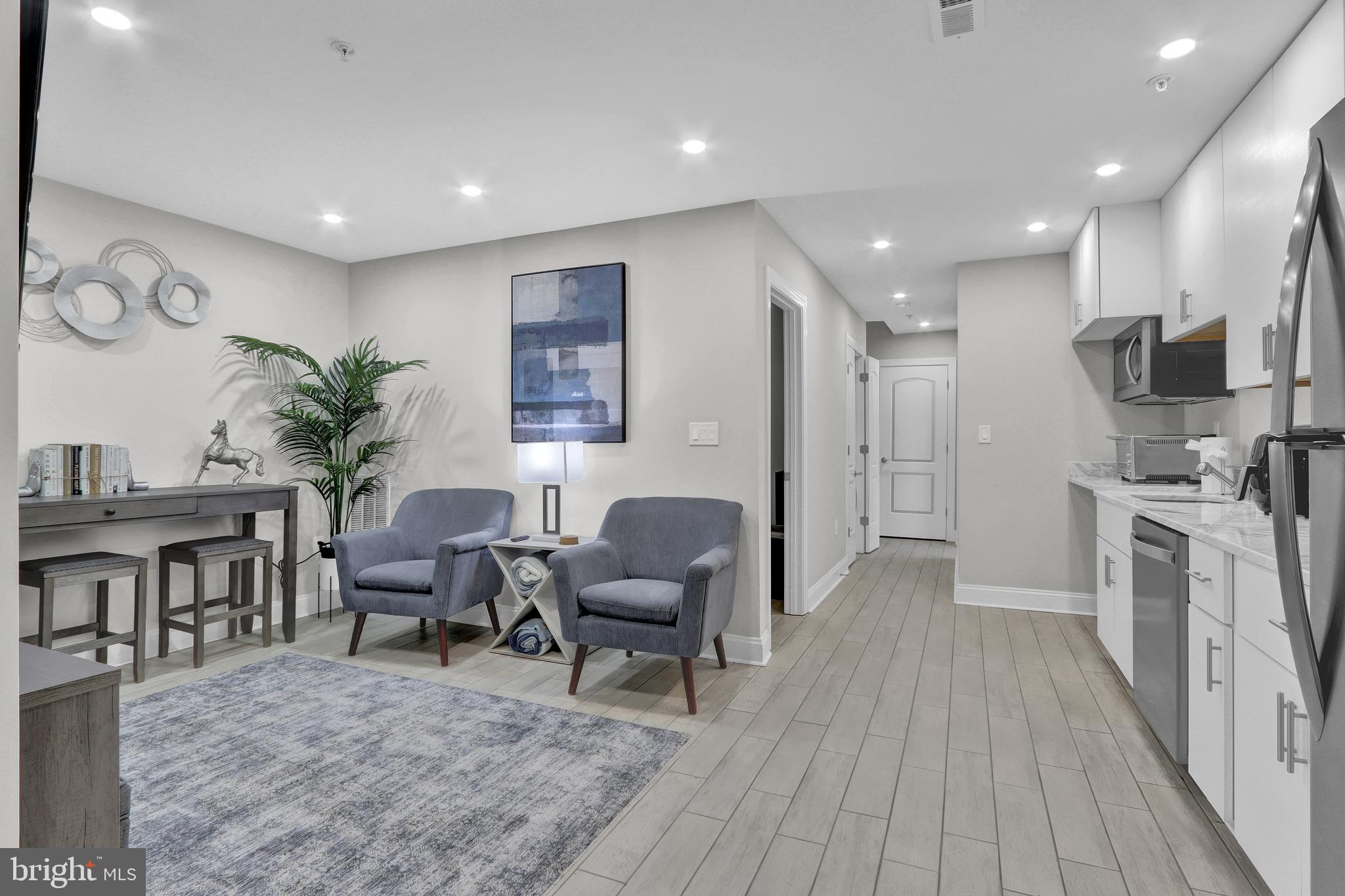 1167 Morse Street Northeast, Unit B1 Washington, DC 20002 - Photo 4 of 18 a living room with furniture and a wooden floor