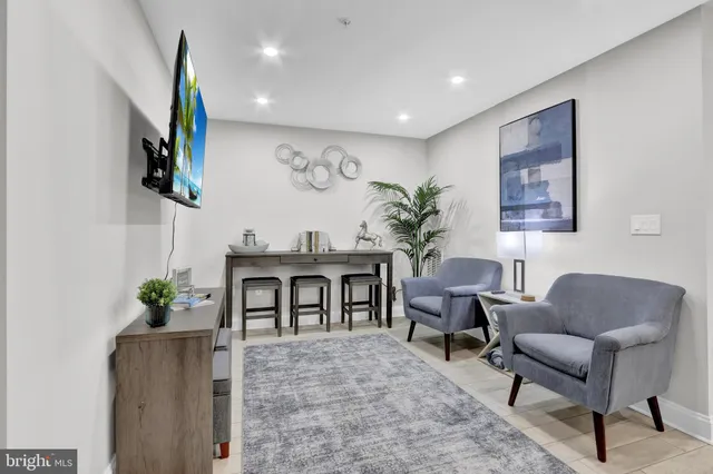 a living room with furniture a piano and a flat screen tv