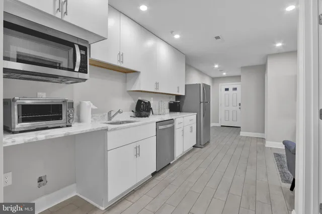 a kitchen with a sink microwave and refrigerator