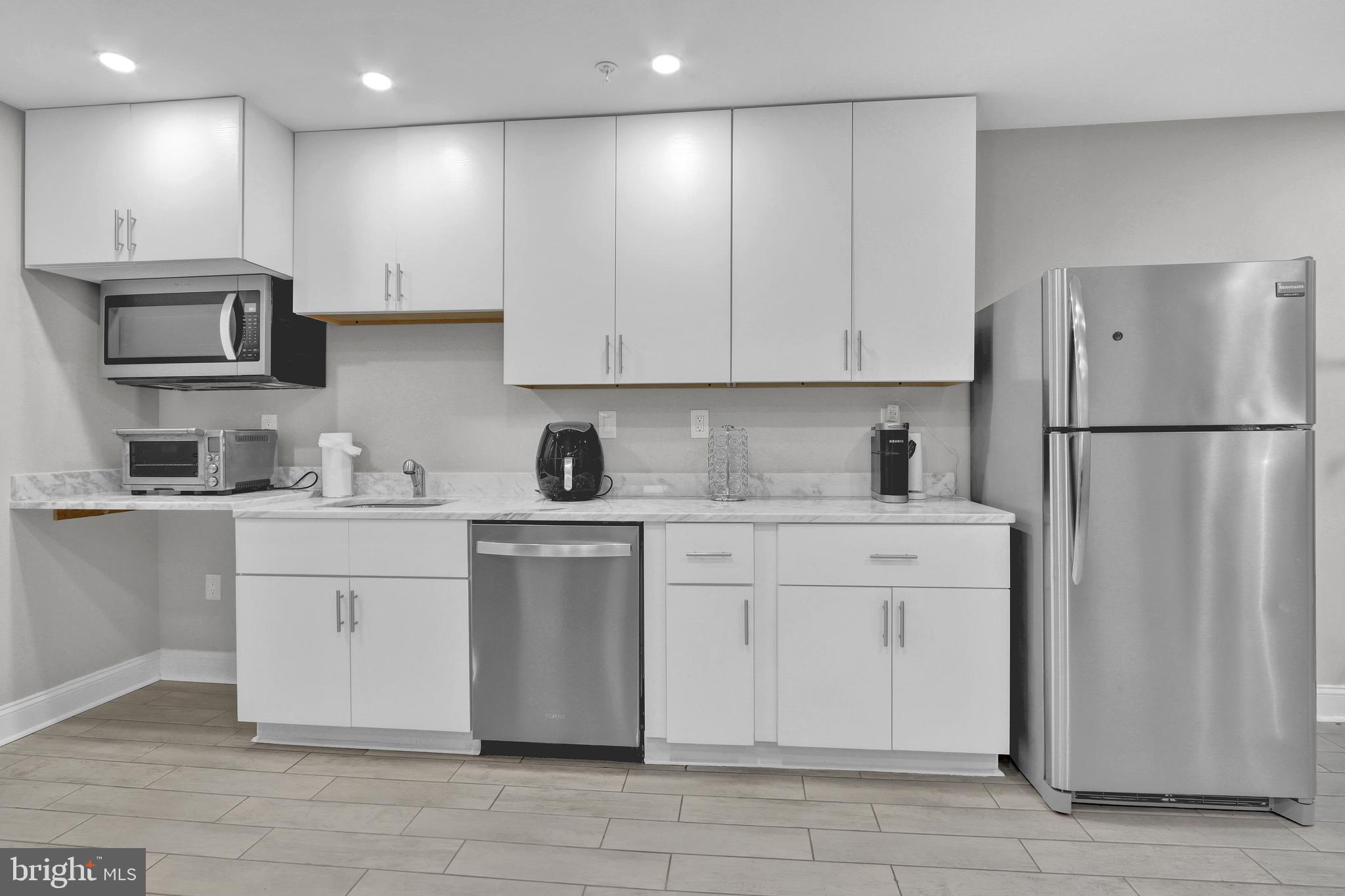 1167 Morse Street Northeast, Unit B1 Washington, DC 20002 - Photo 9 of 18 a kitchen with a refrigerator and a stove top oven