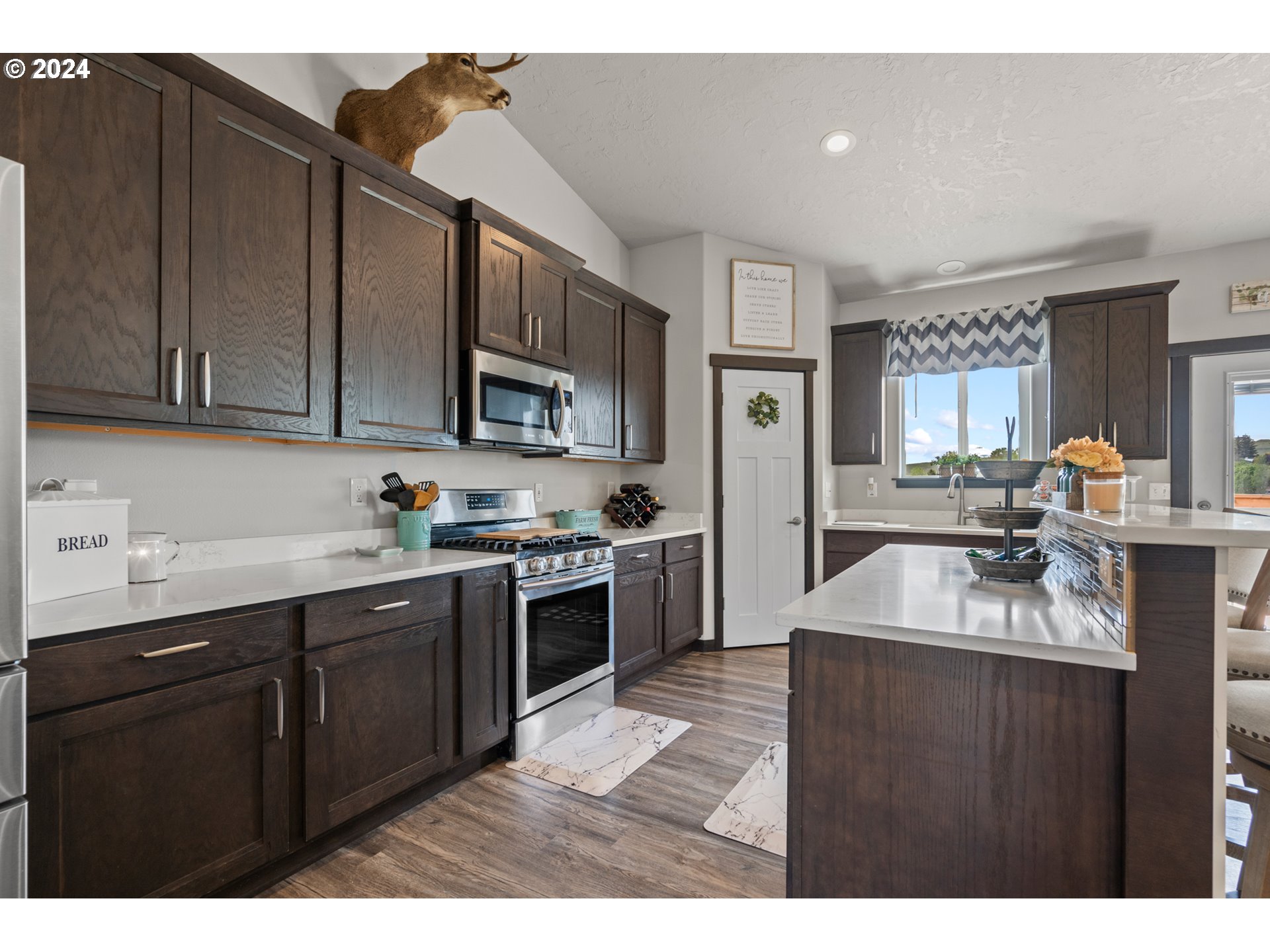 509 Southwest Quinney Place Pendleton, OR 97801 - Photo 8 of 32 a kitchen with stainless steel appliances granite countertop a sink stove and cabinets
