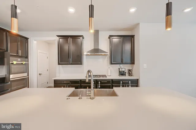 a bathroom with a granite countertop toilet sink and mirror