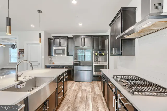 a view of a hallway with wooden floor and windows