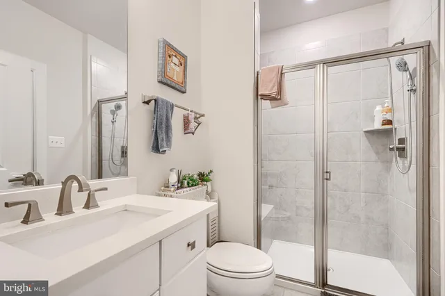 a bed sitting in a spacious bedroom next to a window