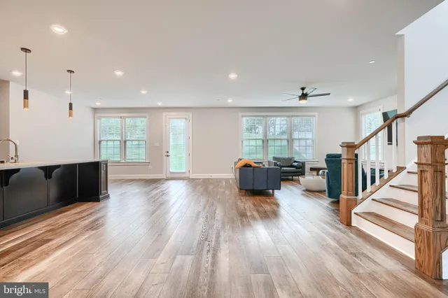 a living room with furniture a flat screen tv and a window