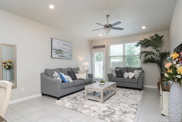a living room with furniture and a large window